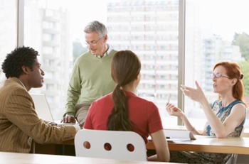 Group of people sitting at a table talking
